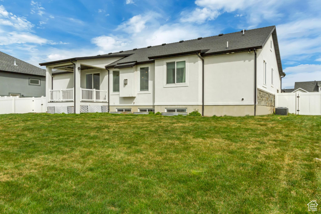 Back of property featuring central AC unit and stucco siding