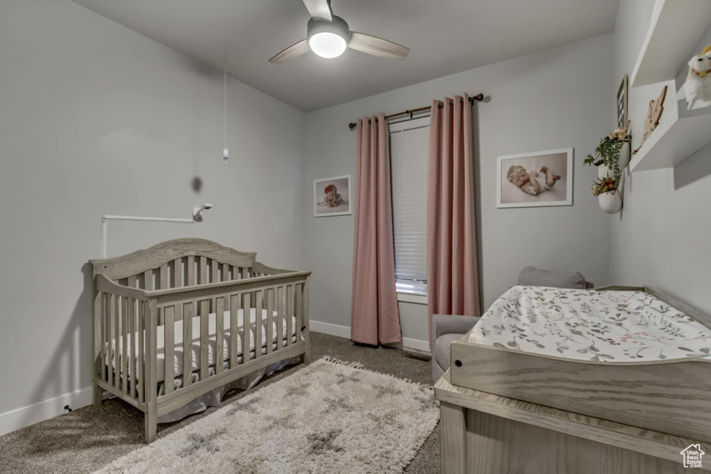 Bedroom with carpet, baseboards, and ceiling fan