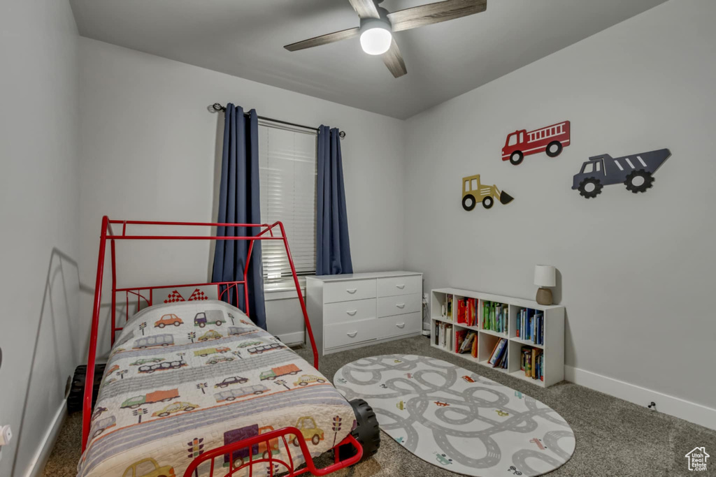 Bedroom with carpet, baseboards, and ceiling fan