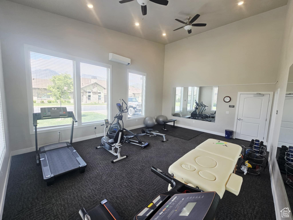 Workout area featuring baseboards, a wall mounted air conditioner, a ceiling fan, recessed lighting, and carpet floors