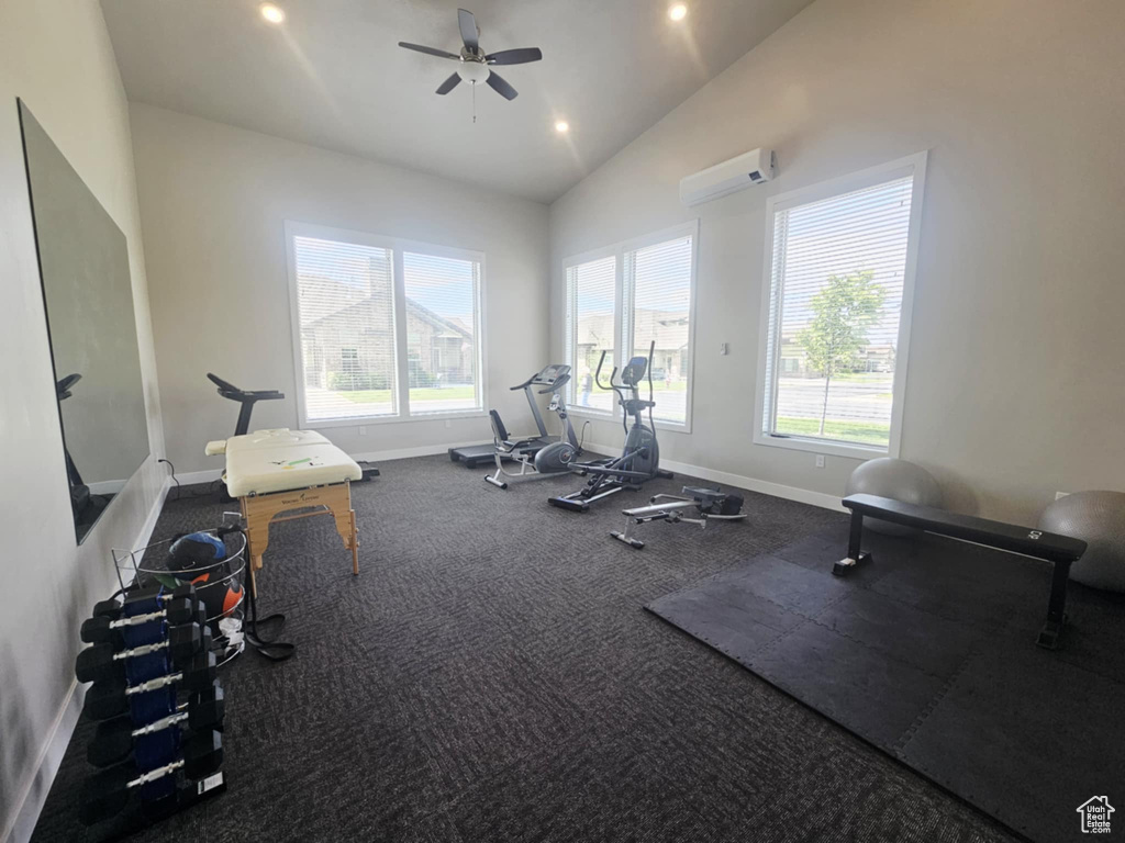 Workout area with a wall unit AC, plenty of natural light, baseboards, lofted ceiling, and recessed lighting