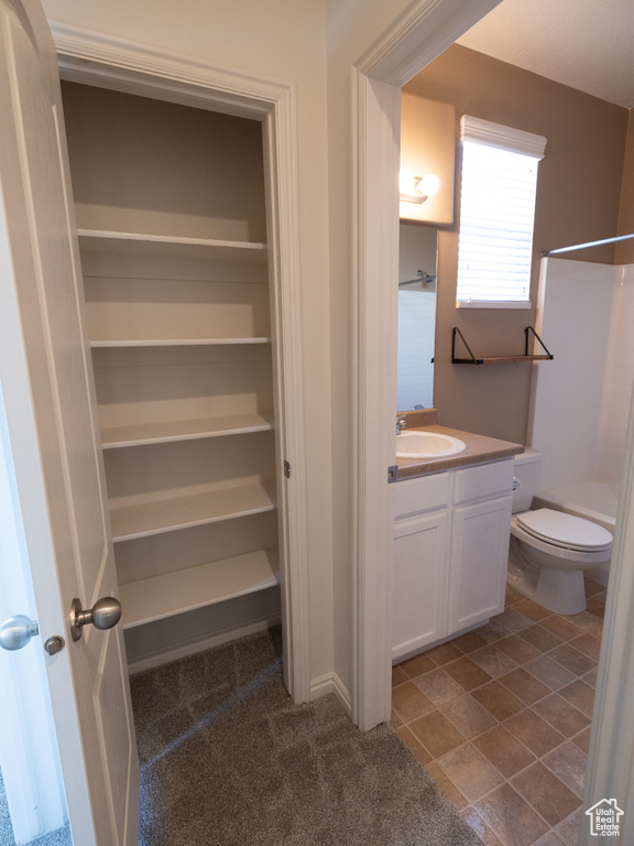 Bathroom with vanity, a shower, and toilet