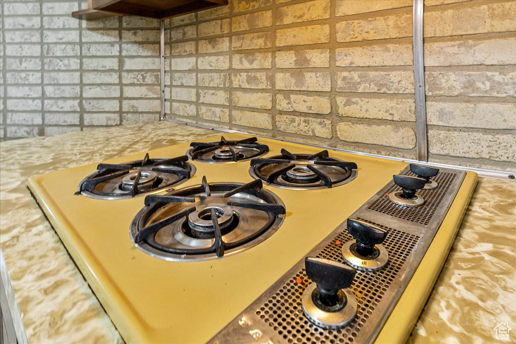 Kitchen view of gas cooktop and ventilation hood