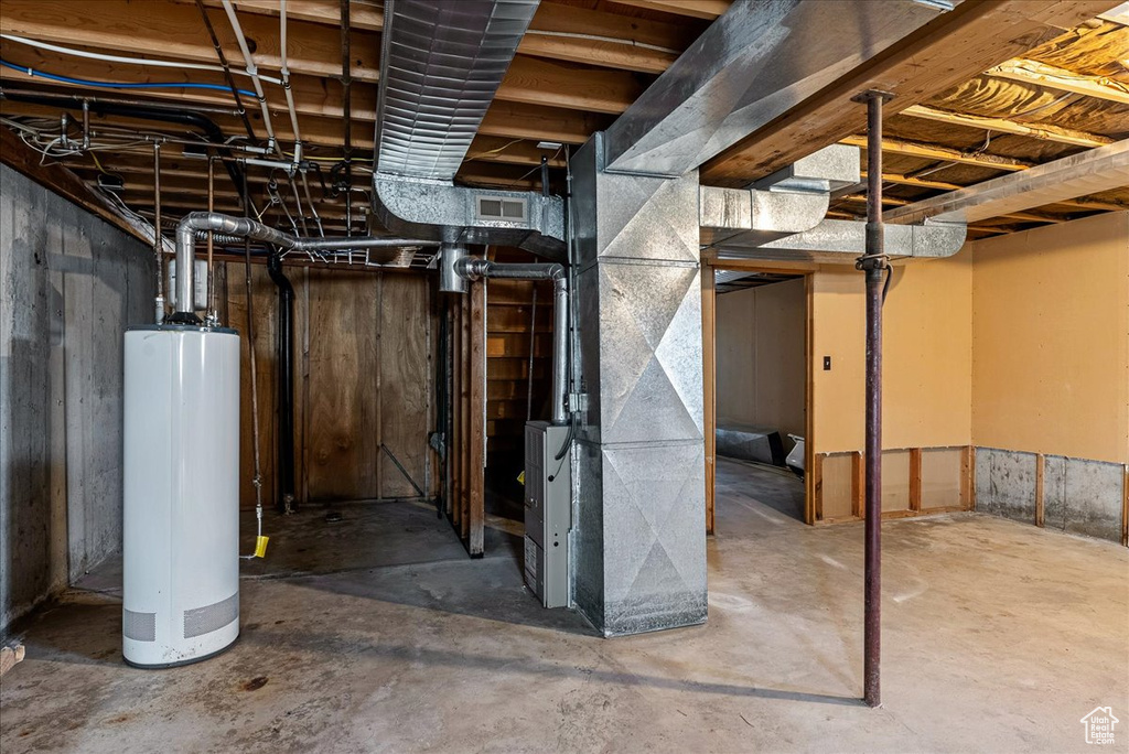 Unfinished below grade area with water heater and heating unit