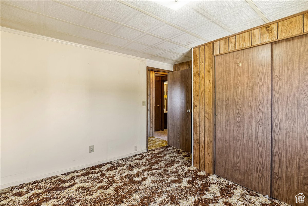 Unfurnished bedroom featuring carpet floors, baseboards, and a closet