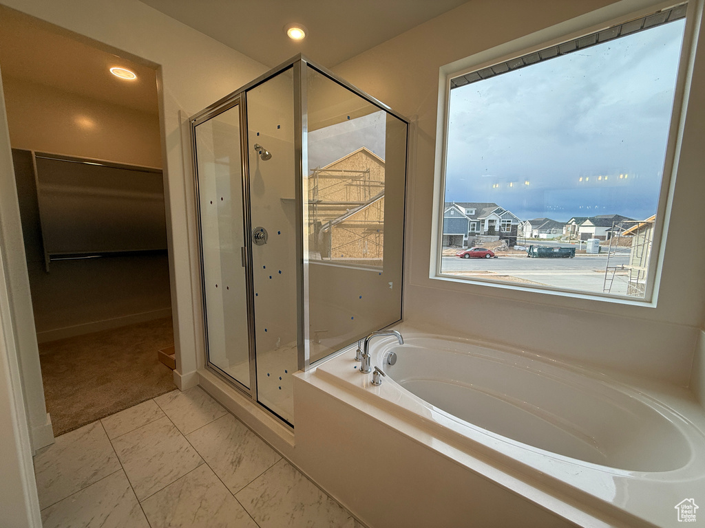 Full bathroom with a shower stall, a bath, and recessed lighting