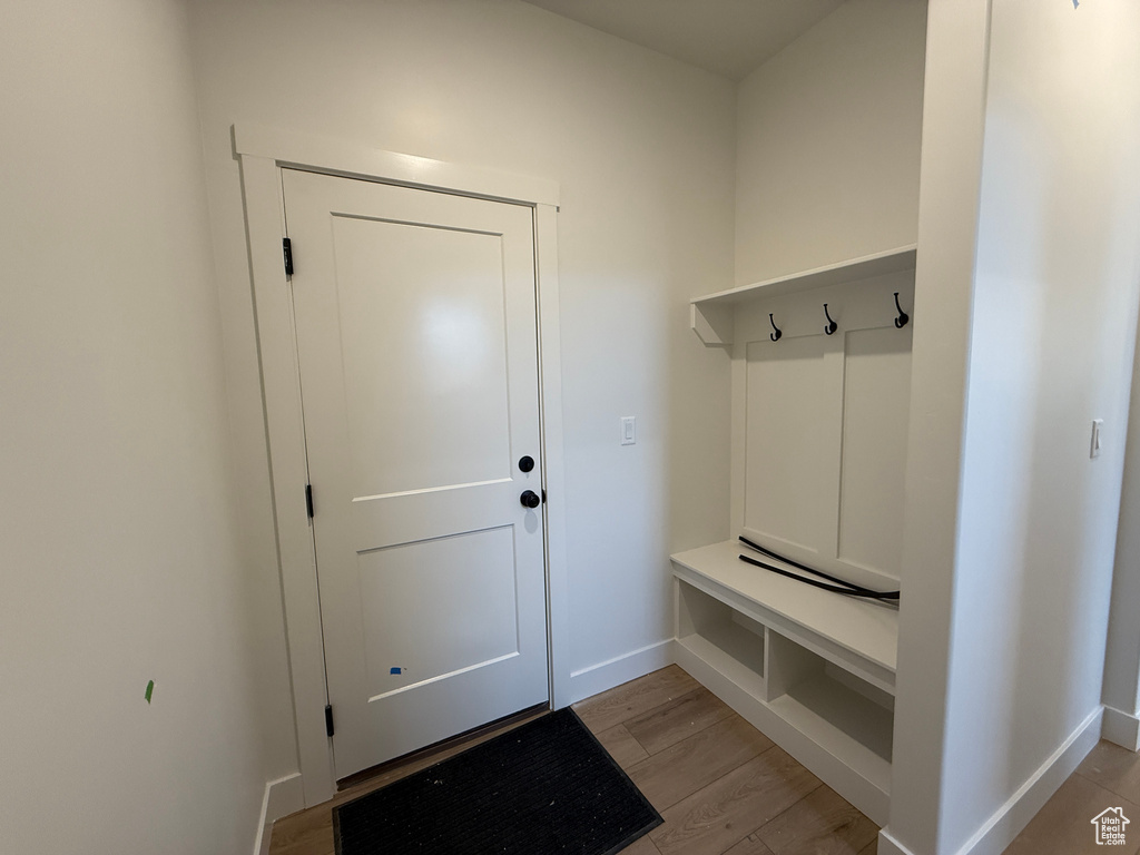 Mudroom with baseboards and light wood-type flooring