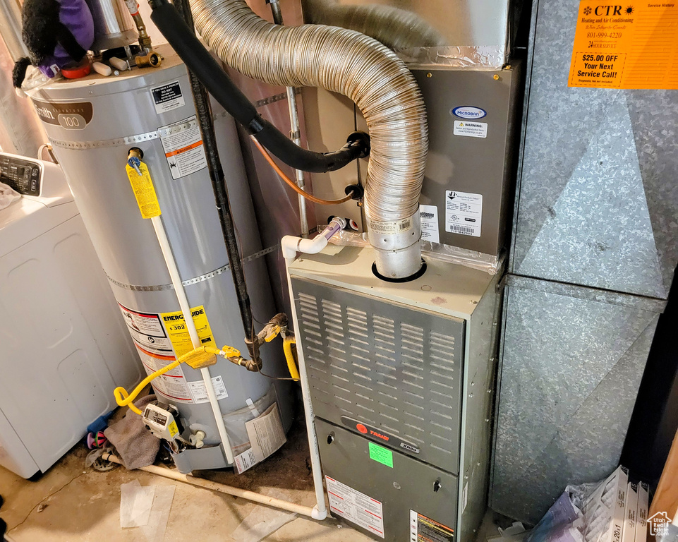 Utilities featuring gas water heater, washer / dryer, and heating unit