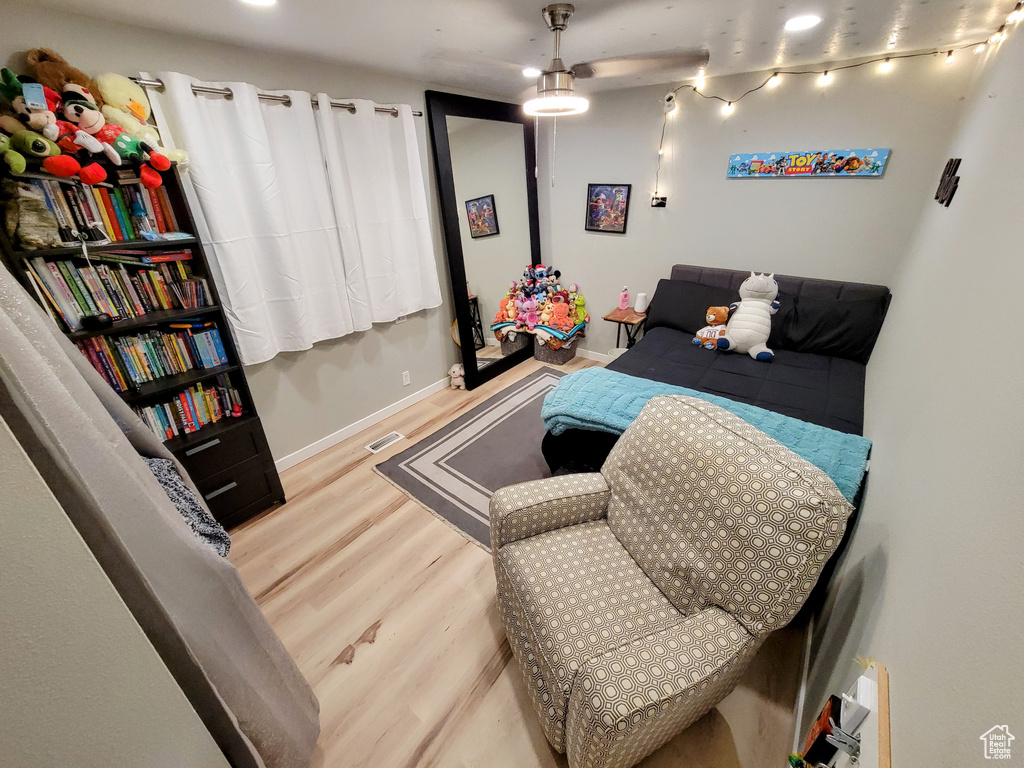 Bedroom with wood finished floors and baseboards