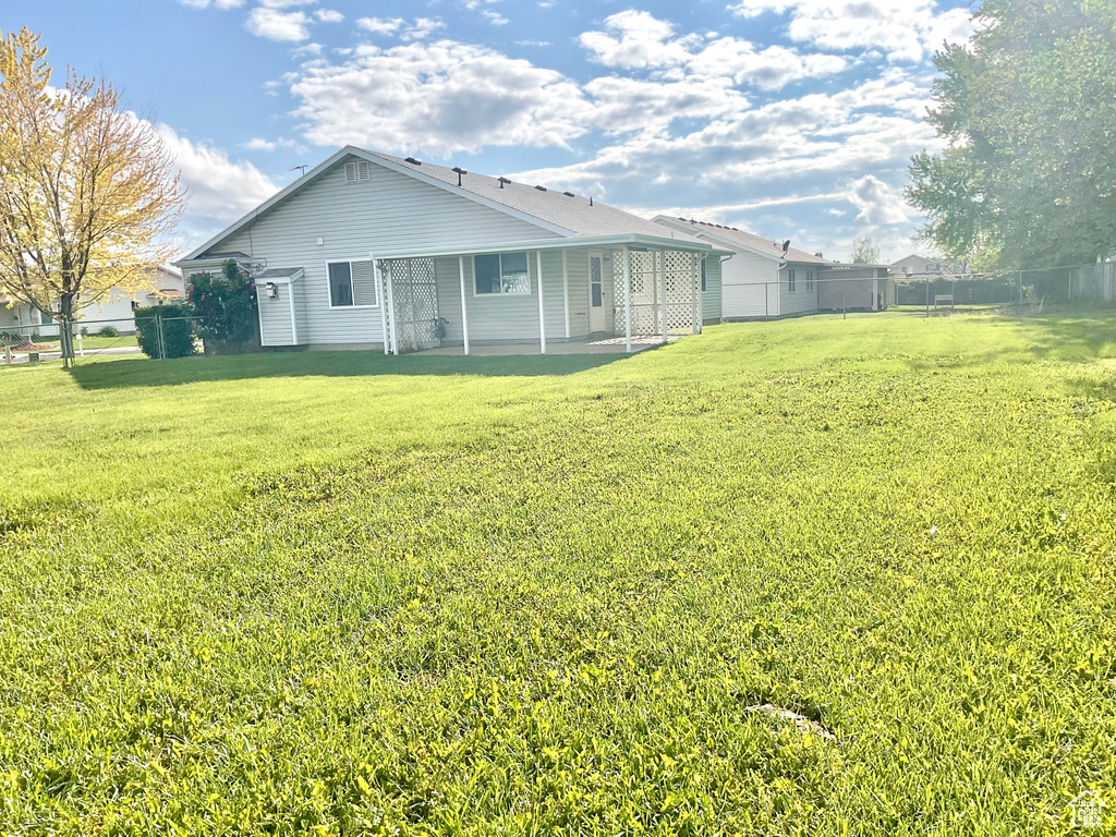 Rear view of property featuring a patio
