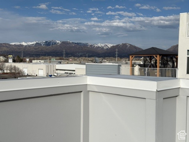 View of patio with a mountain view, a gazebo, and a balcony