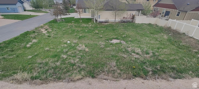 View of yard featuring fence and a residential view