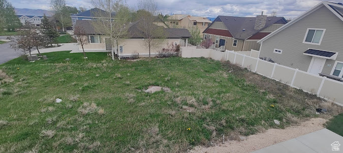 View of yard with a residential view and fence