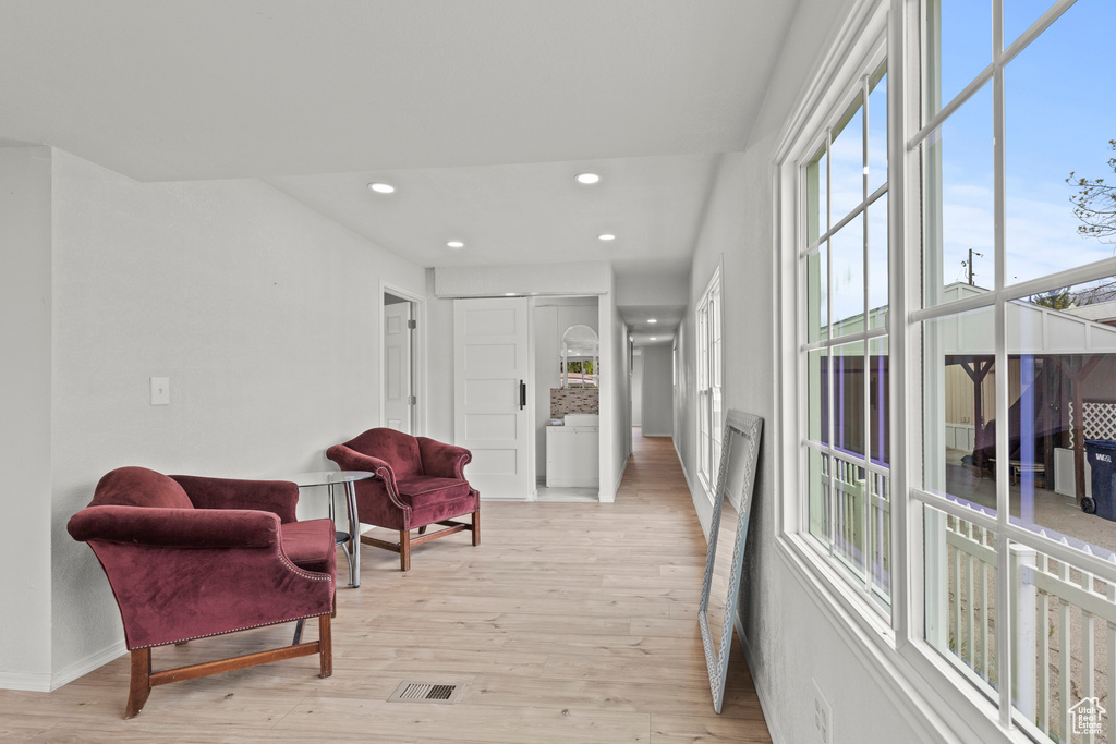 Sitting room featuring light wood finished floors, recessed lighting, and baseboards