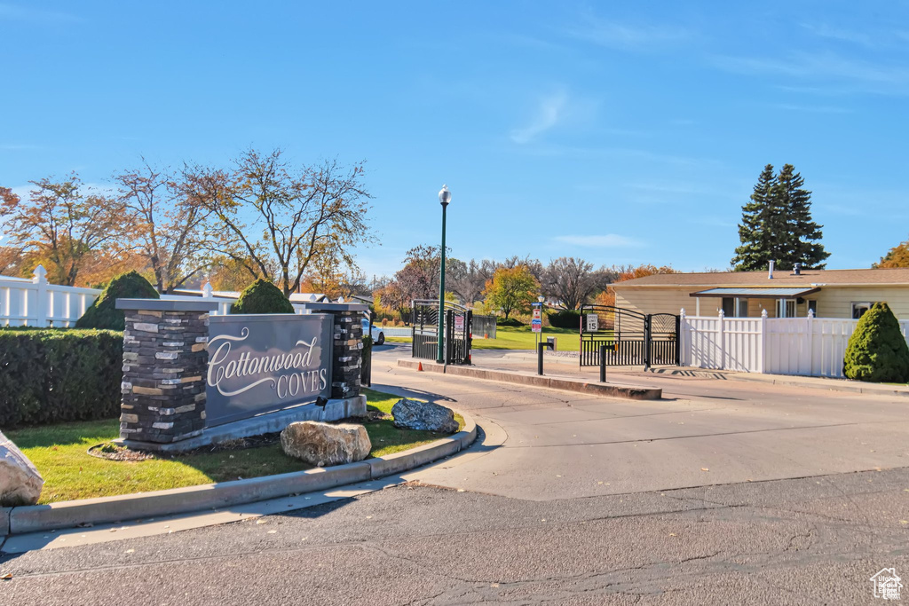 View of asphalt street featuring curbs and street lighting