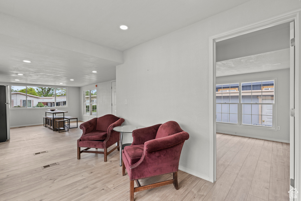 Sitting room featuring recessed lighting, wood finished floors, and baseboards