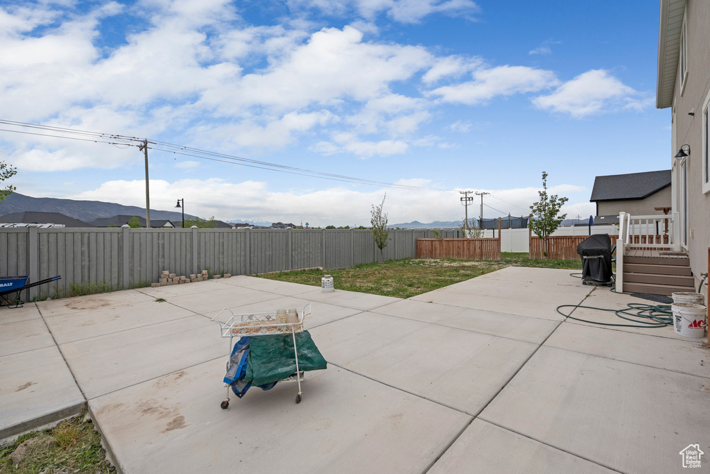 View of patio with a fenced backyard and a mountain view