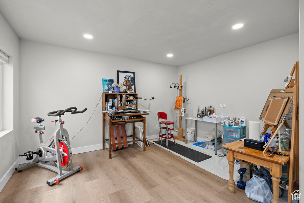Exercise area featuring wood finished floors, recessed lighting, and baseboards
