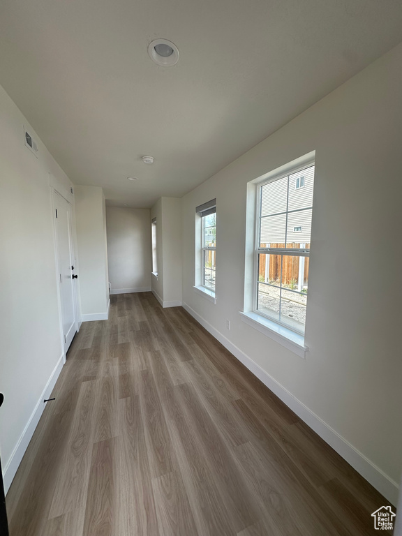 Unfurnished room with baseboards and wood finished floors