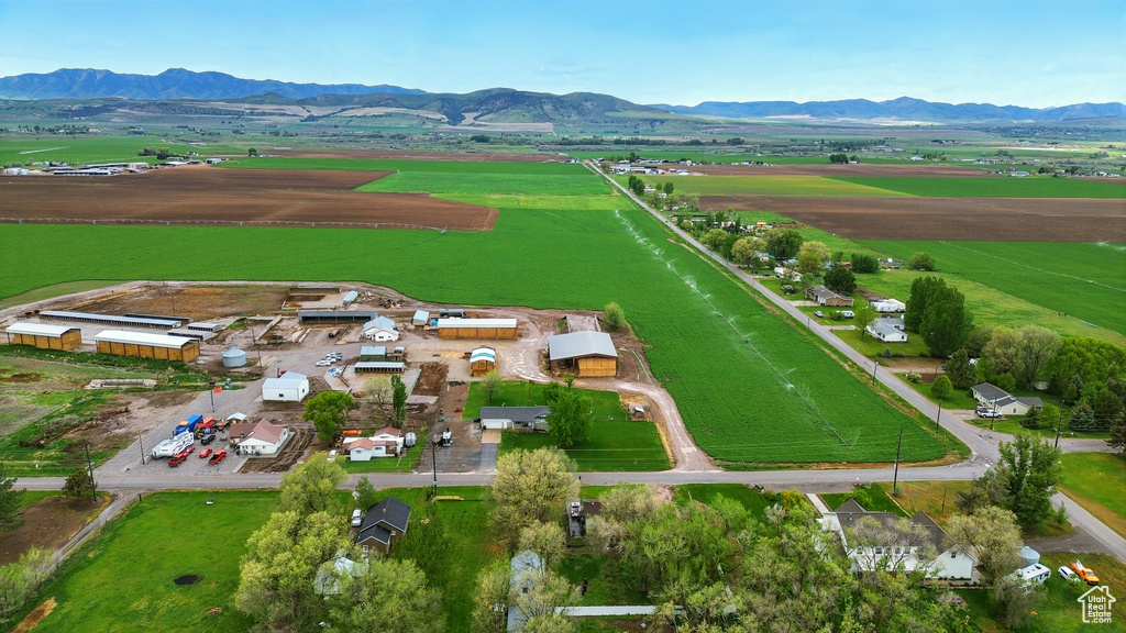 View of rural area with a mountainous background and large plots for crops