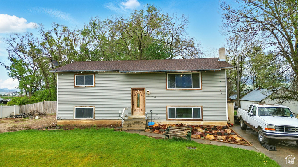 Split foyer home with entry steps and a chimney