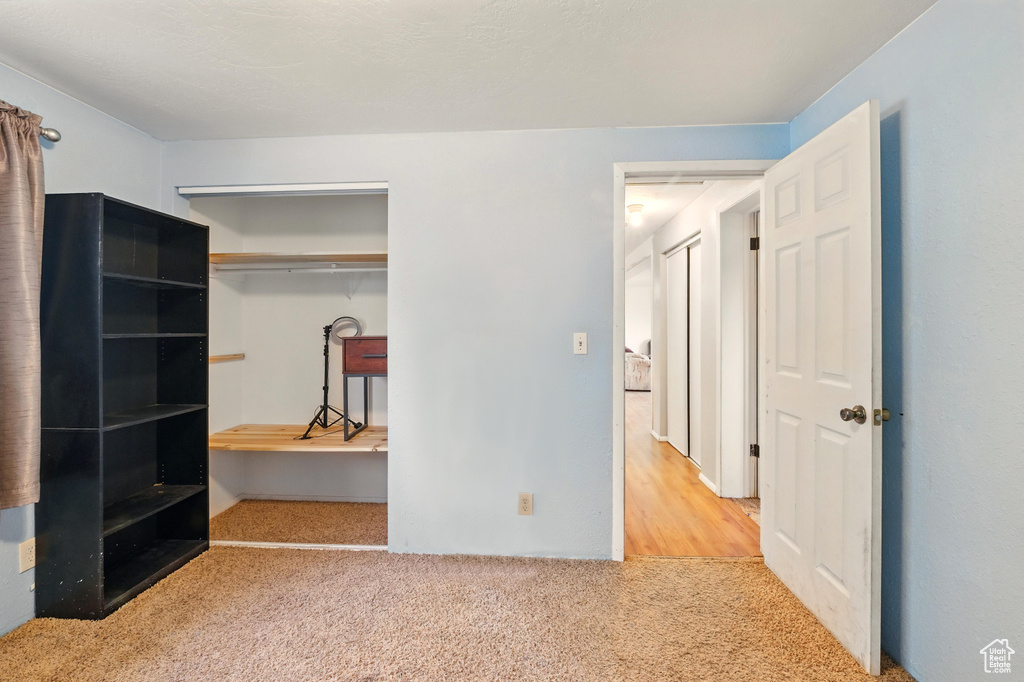 Unfurnished bedroom with carpet floors and a closet