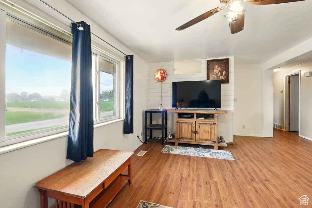 Living room featuring a ceiling fan and light wood-type flooring