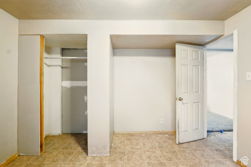 Unfurnished bedroom featuring tile patterned flooring
