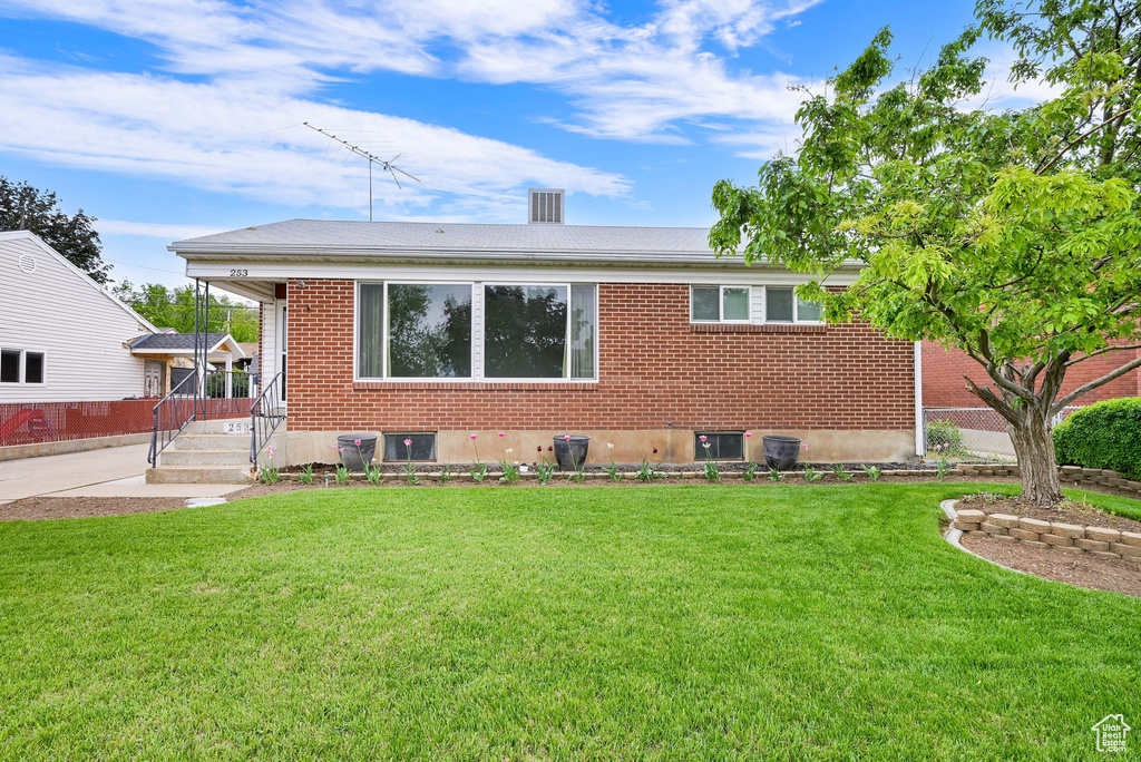 View of front of house with brick siding and roof with shingles