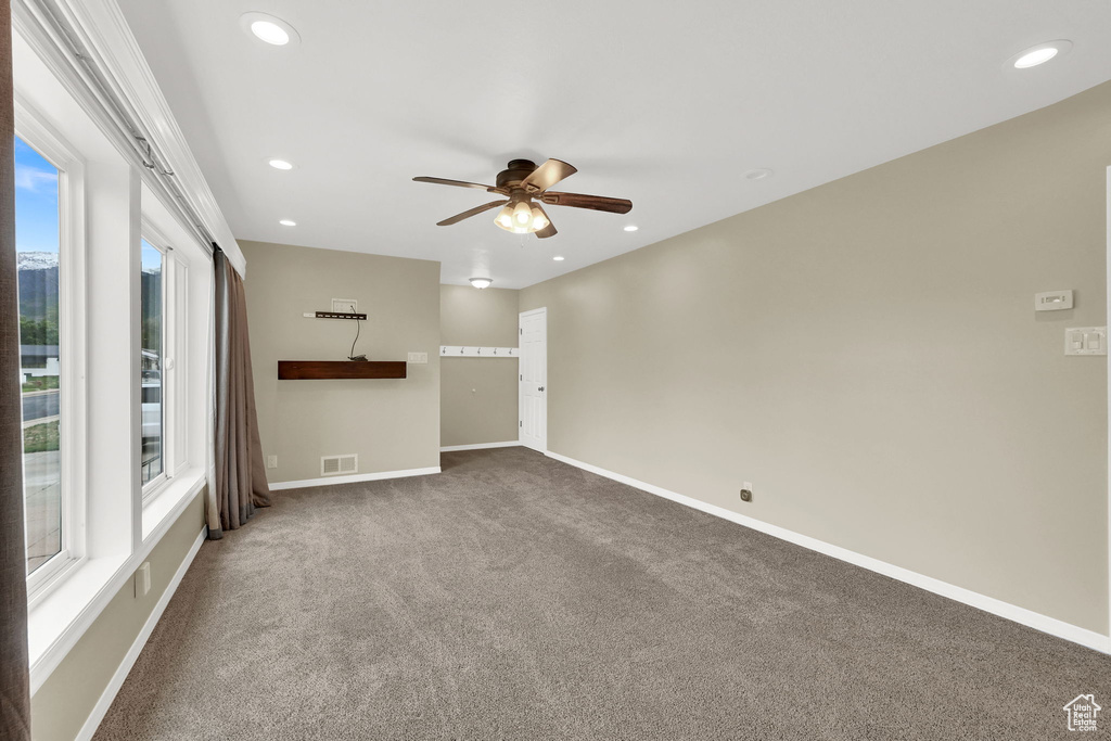 Empty room featuring carpet, ceiling fan, recessed lighting, and baseboards