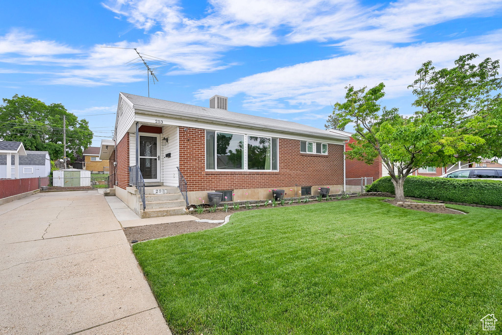 Bungalow with brick siding and concrete driveway