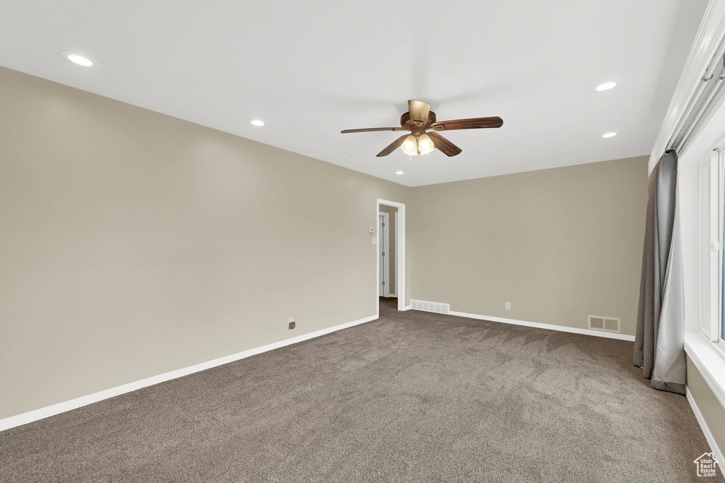 Spare room with a ceiling fan, carpet flooring, recessed lighting, and baseboards