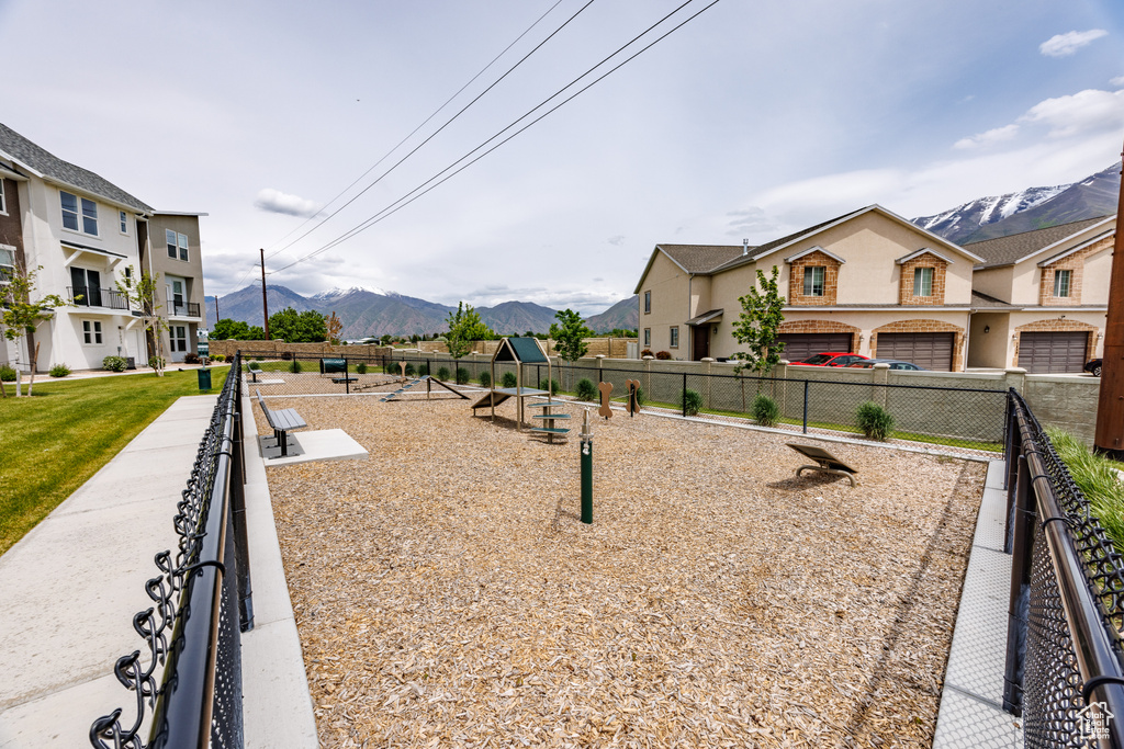 View of community featuring a mountain view, fence, and a residential view
