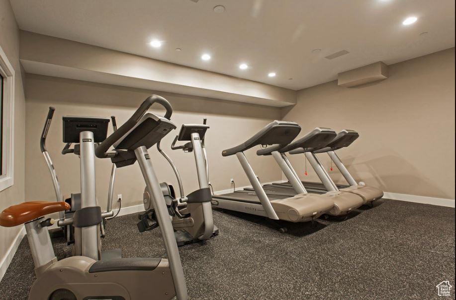 Workout area with baseboards, recessed lighting, and a wall unit AC