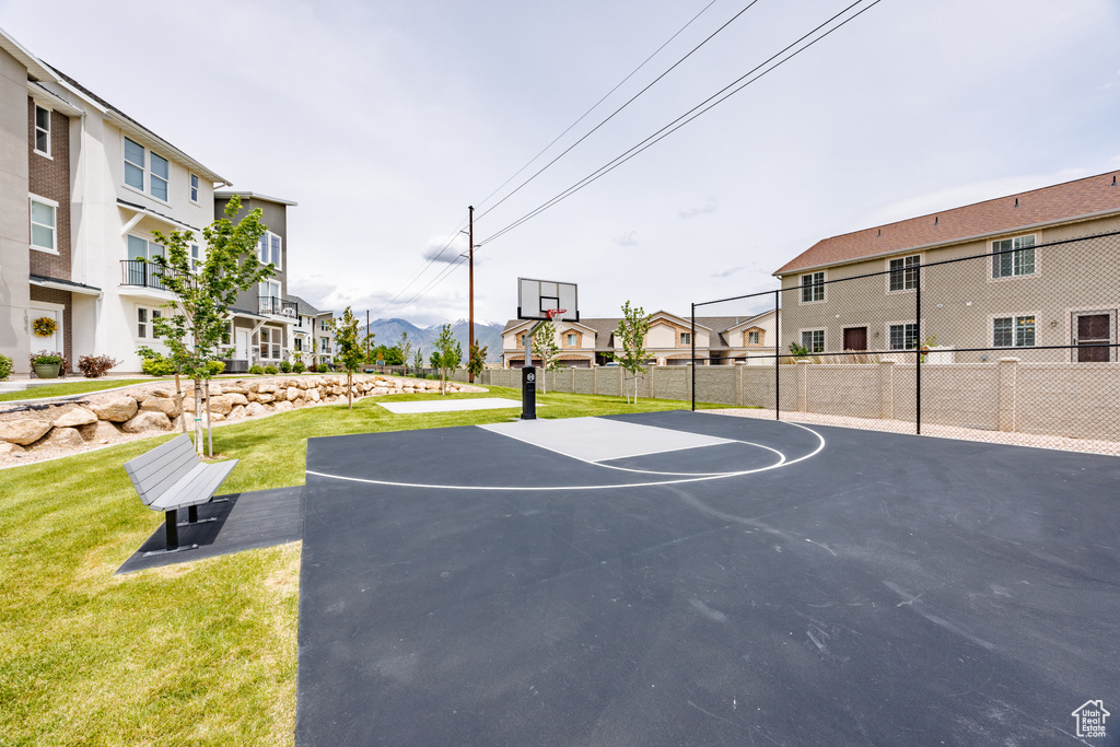 View of sport court featuring basketball court and a residential view