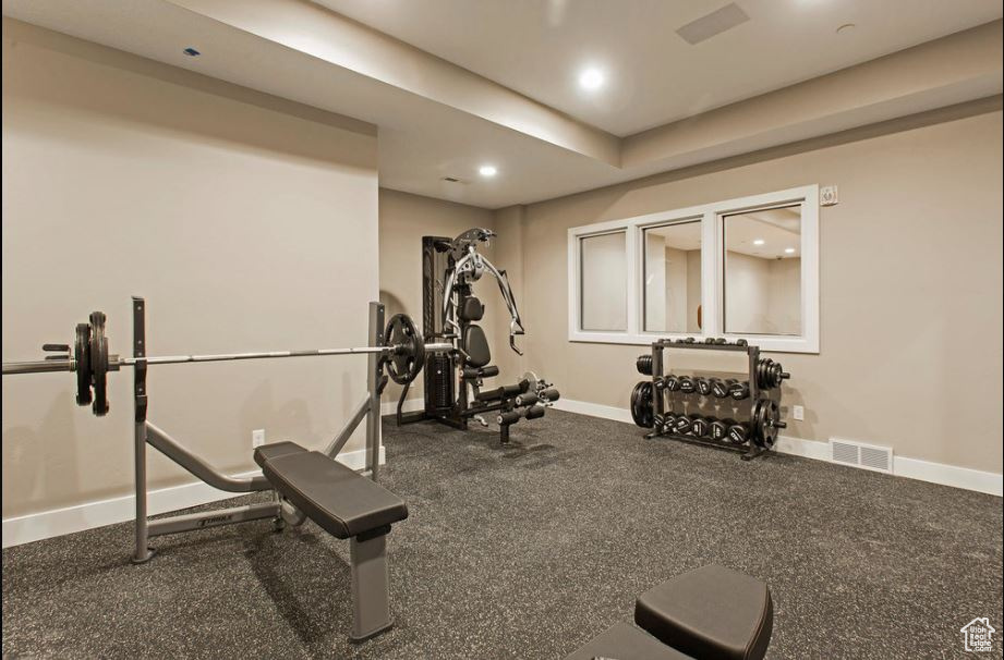 Workout area with baseboards and recessed lighting