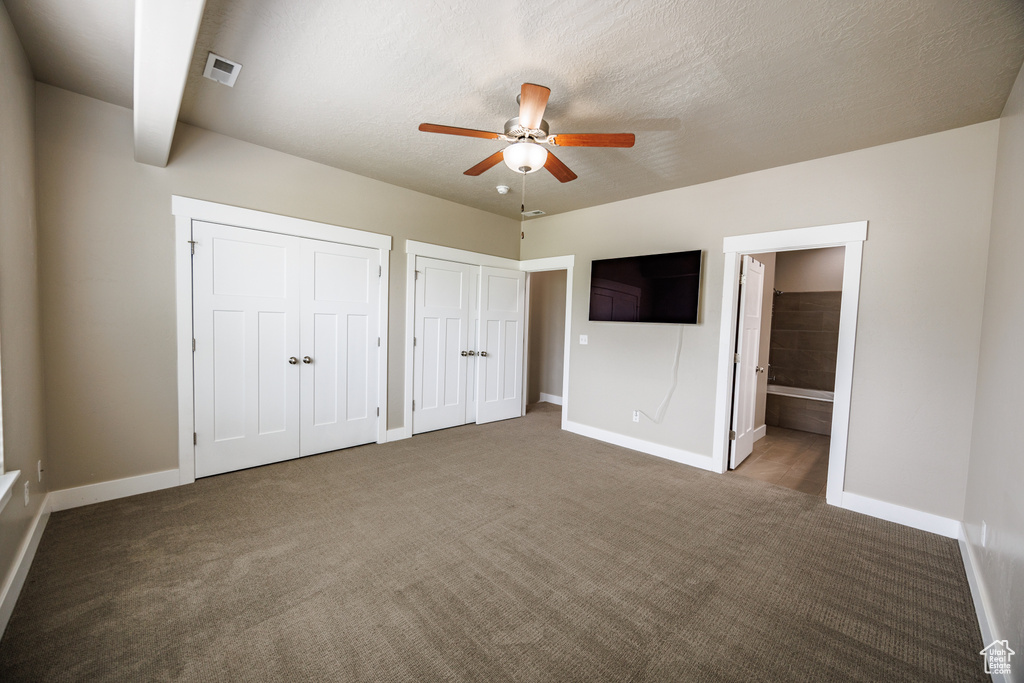 Unfurnished bedroom with multiple closets, baseboards, carpet floors, and connected bathroom