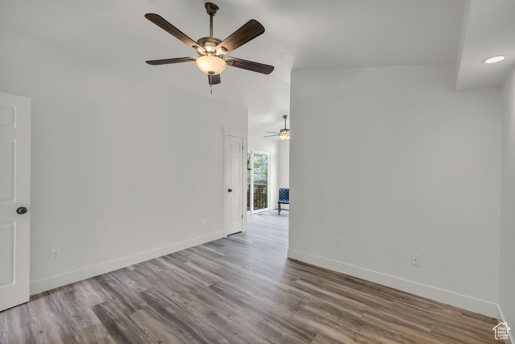 Spare room featuring a ceiling fan, baseboards, wood finished floors, and recessed lighting