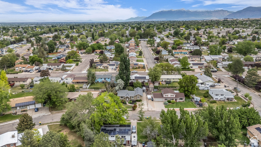 Aerial overview of property\'s location with a mountain backdrop and nearby suburban area