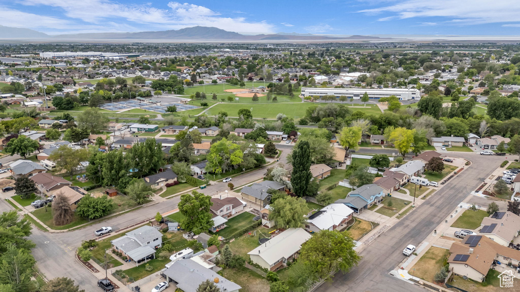 Aerial view of property\'s location featuring a mountainous background and nearby suburban area
