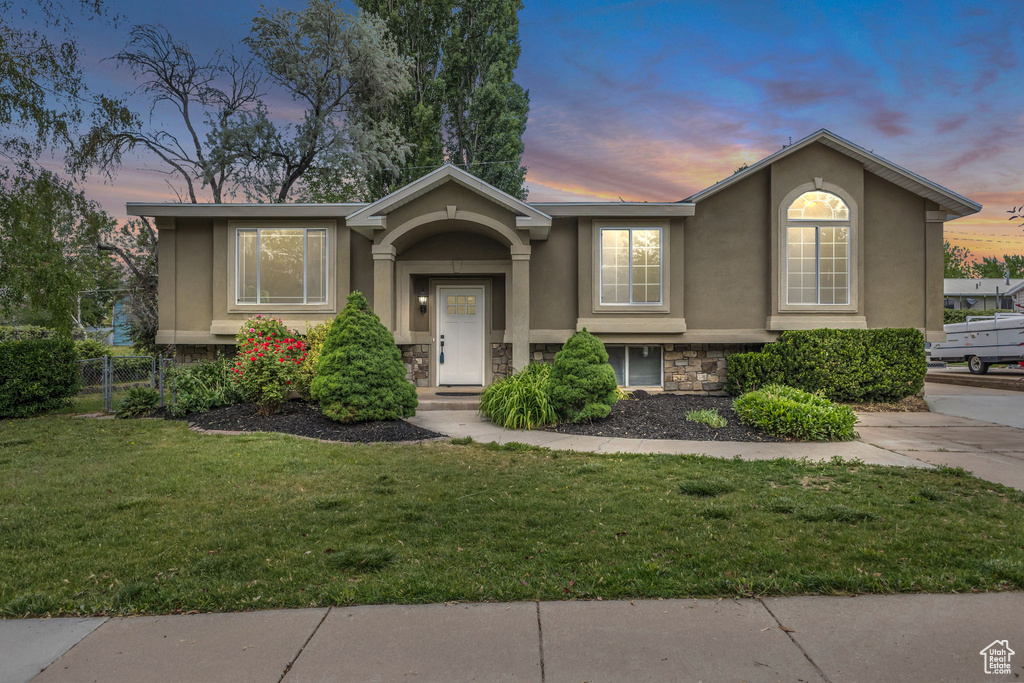 Bi-level home featuring stone siding and stucco siding