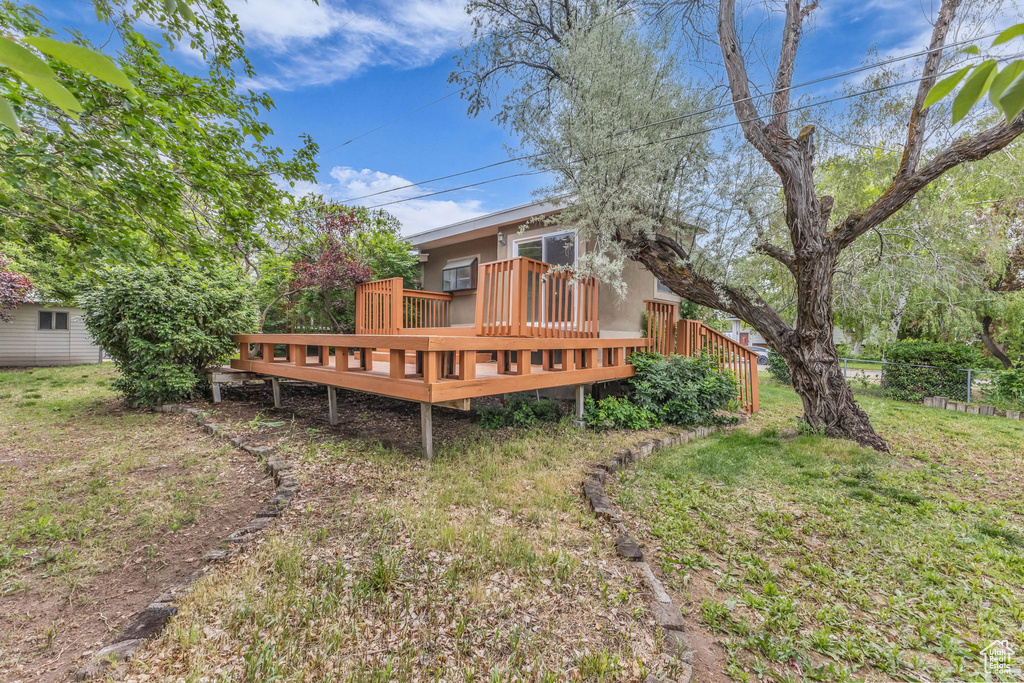 Back of house with a wooden deck and fence