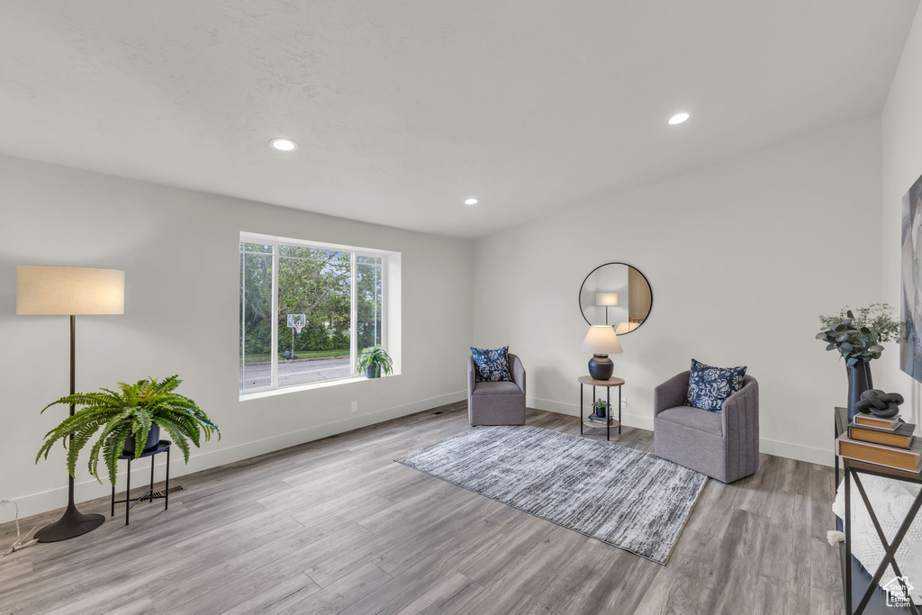 Living area featuring wood finished floors, baseboards, and recessed lighting