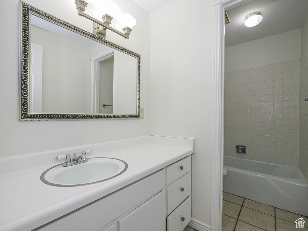 Full bathroom with tile patterned floors and vanity