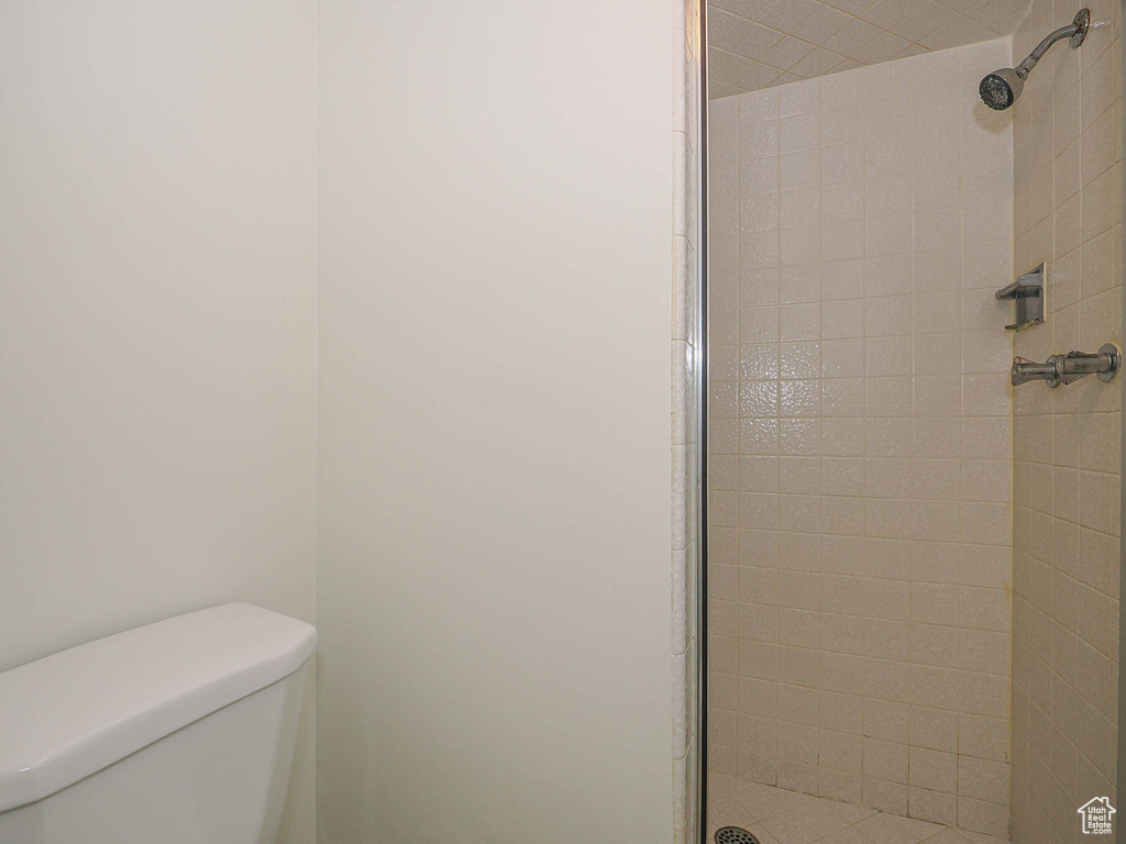 Full bath with a stall shower and toilet