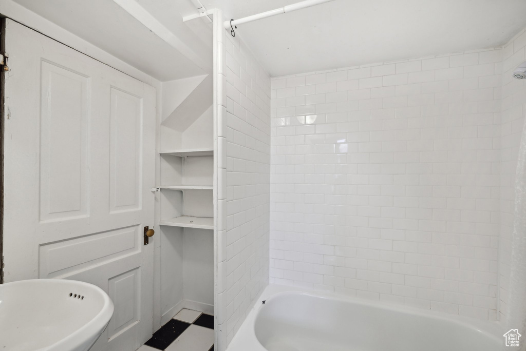 Full bathroom featuring tile patterned floors, bathing tub / shower combination, and a sink