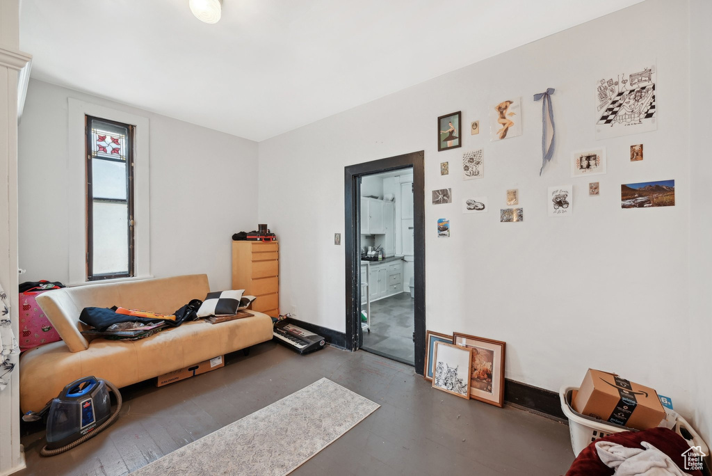 Living room with concrete floors and baseboards