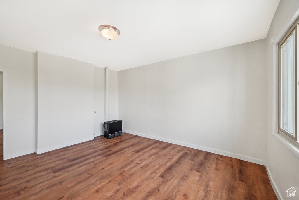 Empty room featuring wood finished floors and baseboards