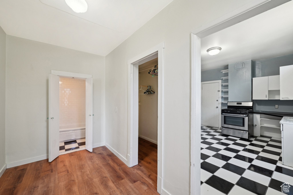 Corridor with tile patterned floors and baseboards