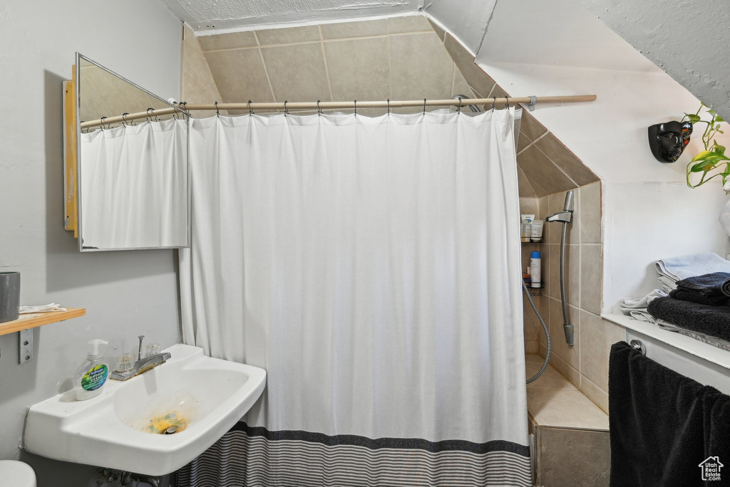 Full bathroom featuring a shower with curtain and a sink